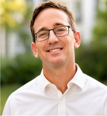 Zach, founder of Cornerstone English Coaching, smiling in a white shirt.